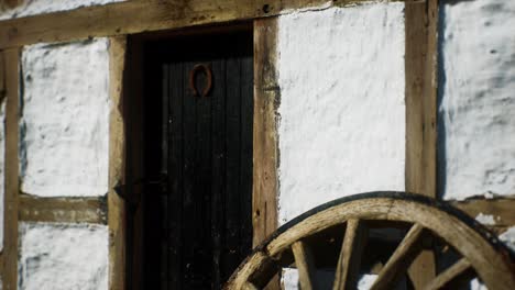 old-wood-wheel-and-black-door-at-white-house